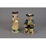 Two Kevin Francis ceramic character jugs, modelled as Vic Schuler seated with jug of beer and