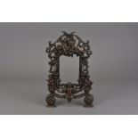 A pair of Edwardian cast iron easel frames, decorated with cherubs amongst festoons of ribbons and