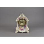 A Royal Bonne ceramic transfer printed mantel clock, the Ansonia American brass movement having a
