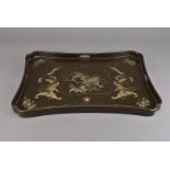 A Chinese lacquered tray, of shaped rectangular form centred with Buddhistic lion dogs and five claw