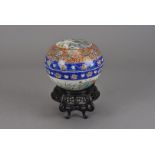 A 19th Century Japanese circular bowl and cover, the removable lid with exterior polychrome