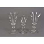 Three early 19th Century toasting glasses, with illusion trumpet shaped bowls, double knopped