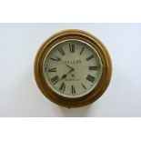 An early 20th Century oak cased circular wall clock, with white painted dial, roman numerals, marked
