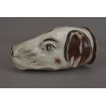 A 19th Century Staffordshire dog mask stirrup cup, in brown and cream enamels, 12 cm long