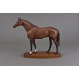 A Beswick model of a racehorse, on wooden oval plinth base, 31 cm high