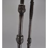 Two hardwood tribal staffs, one carved with three African heads all having face markings, 98 cm, the