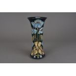 A Moorcroft Pottery vase, signed and designed by Philip Gibson, of everted sleeve form in the Blue