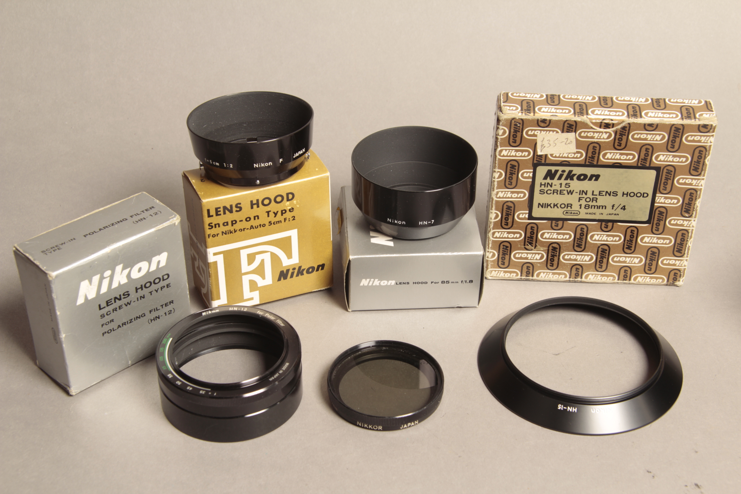 Nikon Lenshoods, an early 'F' type for 50/2, an HM-12 with a Nikkor polarising filter, HN-15, HN-