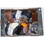 A box of camera accessories, including Rolleiflex plates, cases, flash cables, filters etc