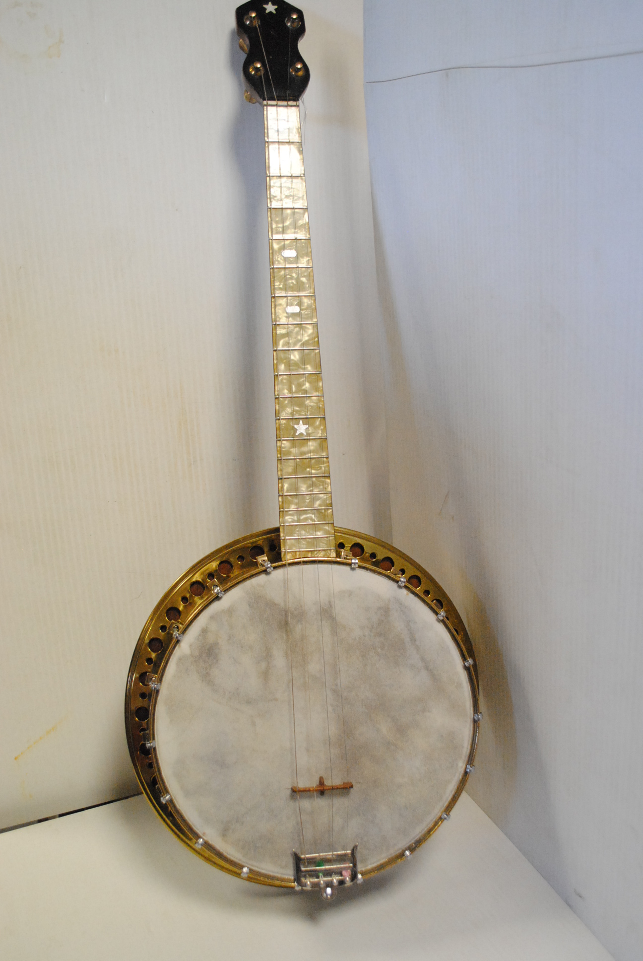 Banjo, four string resonator banjo, 19 fret finger board with simulated mother of pearl
