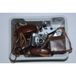 A box of vintage cameras, Canon Canonet, Kodak Retinette, Agfa etc