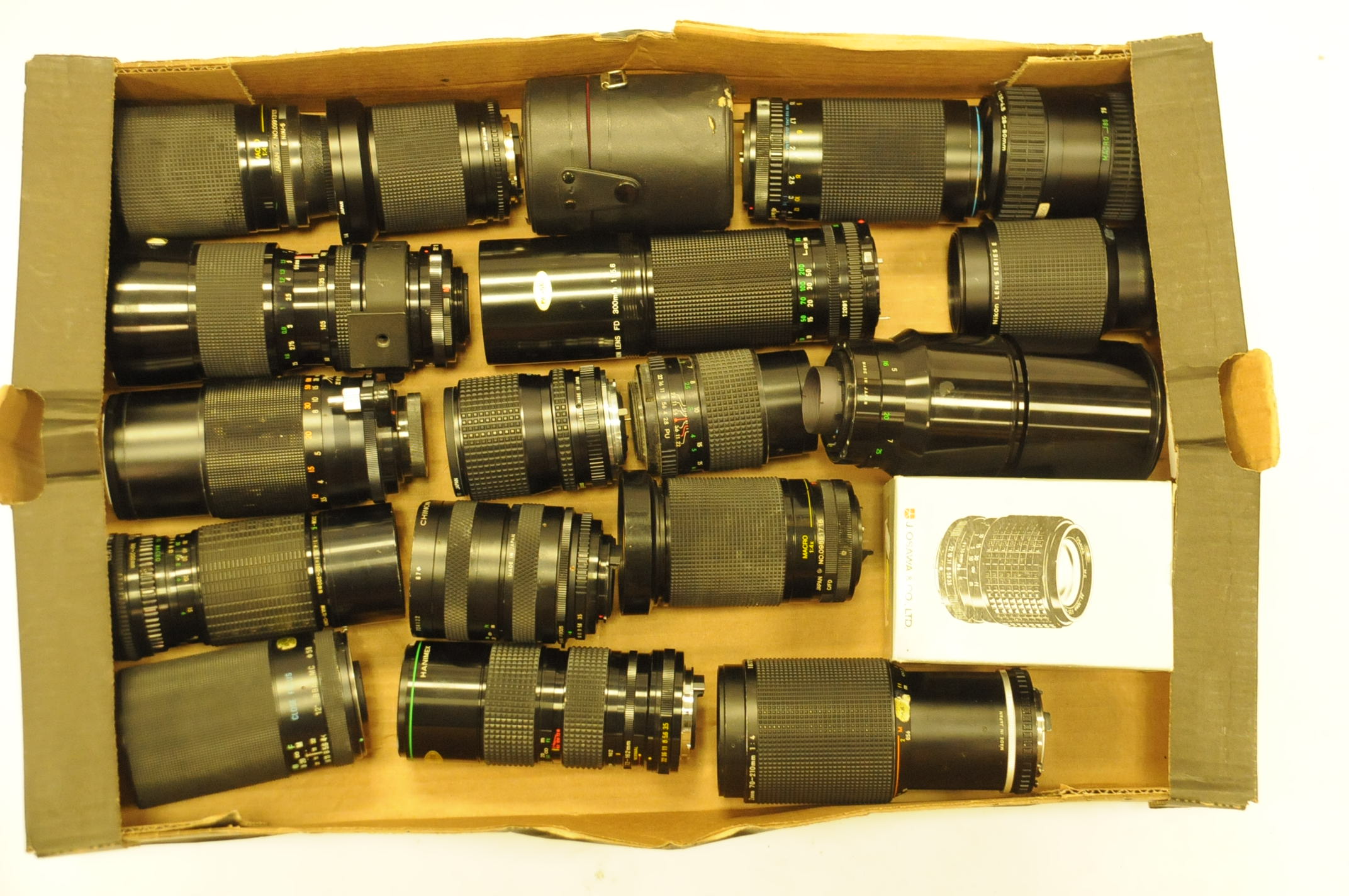 A collection of zoom and telephoto lenses, to include Soligor, Vivitar, Hanimex and other examples