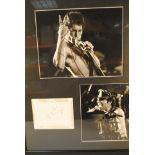 Freddie Mercury, framed and glazed two B/W photographs of Freddie onstage together with a separate