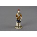A late 18th century Indian painted ivory figure, as a seated mogul in jodhpurs 8 cm H