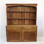 A late 19th early 20th century country oak dresser and top, the plinth base with two panel