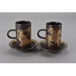 A set of nine Purbeck pottery large coffee cans and saucers, the brown body decorated with gold