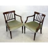 A pair of George III style mahogany armchairs, with green stuff over seats on turned front