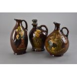 Three Royal Doulton pottery flasks, including 'He's a jolly good fellow', 'Micawber the ever
