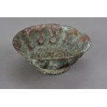 A north Indian copper bowl, with hammered fluting and central chased medallion 13 cm dia.