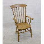 A modern pine windsor style armchair, the curved back rail with five splat back, turned rails,
