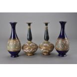 Two pairs of Doulton Slater vases, one pair as narrow necked gourd shaped with floral decoration,