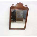 A 19th Century mahogany and satin strung fret carved mirror, with bevelled glass, 84 cm x 51 cm