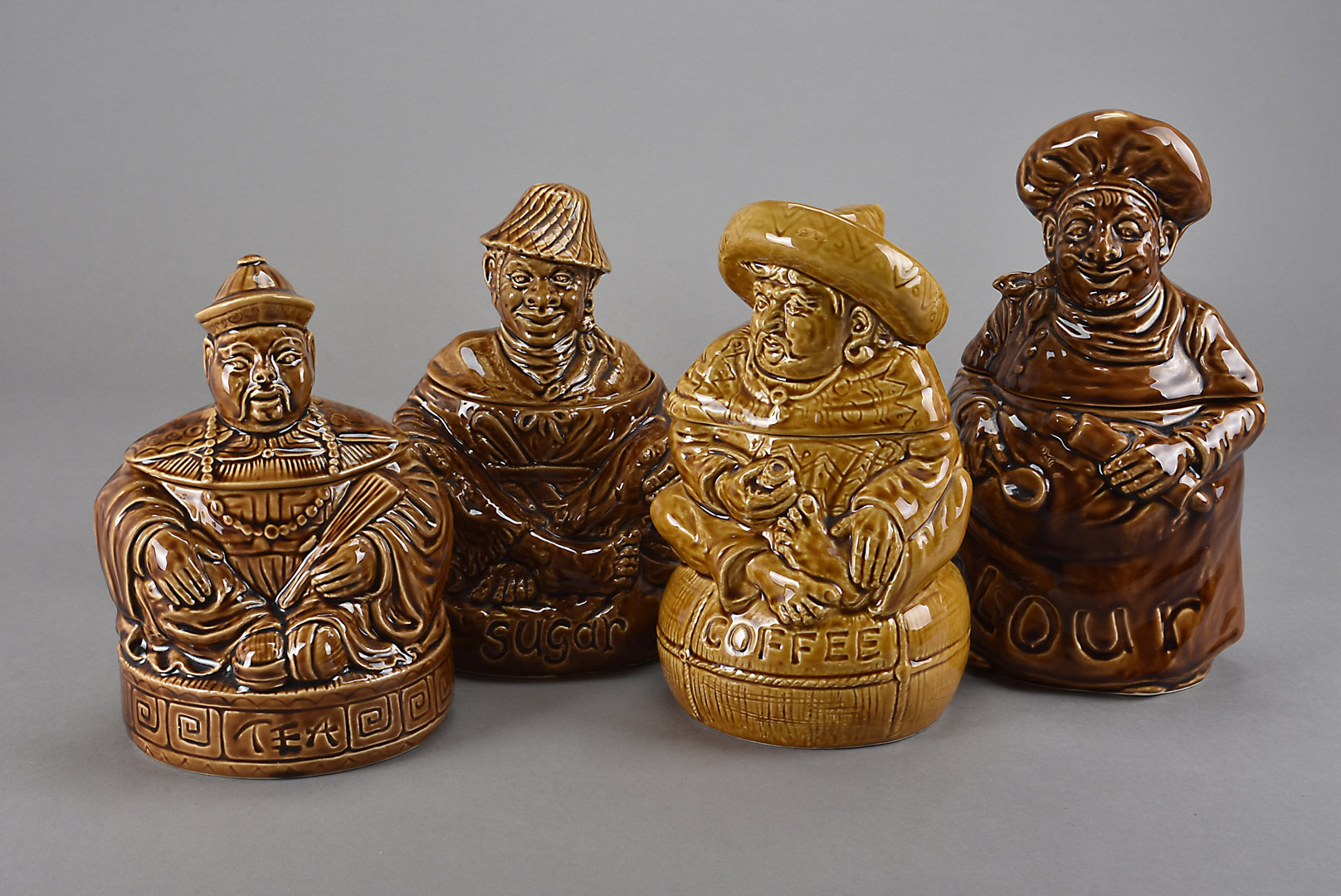 A collection of novelty Sadler storage jars, modelled as figures representing the various