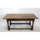 A early 20th century oak refectory table, rectangular top on turned supports united by a lower floor
