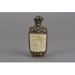 A late 19th Century Chinese silver on copper snuff bottle, with carved ivory panels, embellished