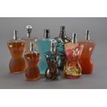 A collection of Jean Paul Gaultier male and female scent bottles, all of typical form with various