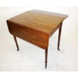 A Victorian mahogany Pembroke table, with turned tapering legs to brass casters 53.5 cm x 81.5 cm