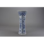 A large delft vase, of trumpeted octagonal form with floral reserves of peony and chrysanthemums,