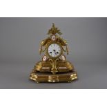 A 19th century French Sevres gilt mantle clock, the gilt painted clock with white enamel dial with