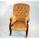 A mustard yellow upholstered button back armchair, on ceramic and brass casters