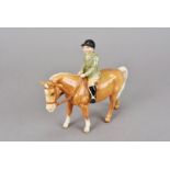 A Beswick figure of boy atop palomino pony, No 1500