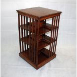 An early 20th Century oak revolving bookcase, of rectangular shape, with three open sections to each