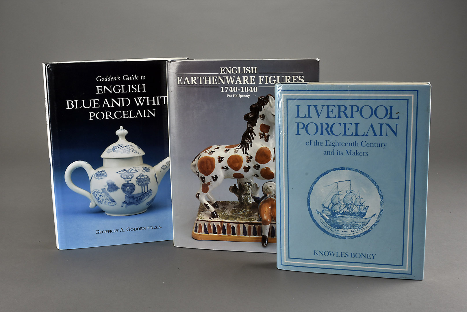 A collection of antiques reference books, including Godden's English Blue and White Porcelain,