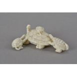 A Japanese Meiji ivory figural group, modelled as a tortoise and her three young, one surmounting