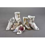 A collection of twenty four modern porcelain miniature shoes, with certificates together with four