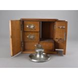 A Victorian oak smoker's cabinet 30.5 cm H, together with a pewter capstan ink well (2)