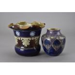 A Royal Doulton secessionist jardinière, together with an Arts & Crafts style Doulton vase in purple