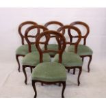 A set of six reproduction beech balloon back dining chairs, with green floral stuff over seats