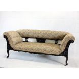 A late Victorian carved and upholstered saloon settee, having decorative scroll and shell design
