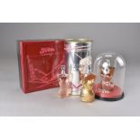 A collection of Jean Paul Gaultier gift boxes, including a gold Gaultier box with three corset