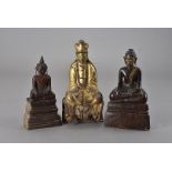 Three wooden south east Asian Buddhas, one with gilt lacquer finish seated in the Dhyana Mudra,