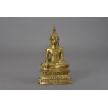 A gilt bronze Burmese Buddha, seated in the Bhumisparsha Mudra on lotus leaf base 26.5 cm H