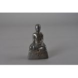 A south east Asian silver covered Buddha, seated in the Bhumisparsha Mudra and on gem set base,