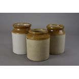 A collection of stoneware storage jars, plus two oak trays and some wrought iron hooks, and