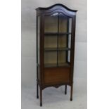 An Edwardian mahogany and satin strung display cabinet, with glazed panel door, three shelf