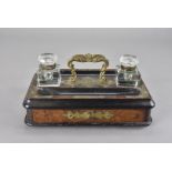 A 19th century brass mounted walnut desk compendium, with twin inkwells, and single drawer